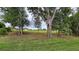 Wooded backyard with mature trees and partial clearing at 555 Sanctuary Golf Pl, Apopka, FL 32712