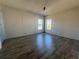 Spacious bedroom with wood-look flooring and large windows at 550 Saint Johns Rd, Tavares, FL 32778