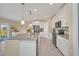 Modern kitchen with white cabinets, gray island and stainless steel appliances at 2854 Black Birch Dr, Ocoee, FL 34761