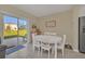 Bright dining area with white table and chairs, view to backyard at 2854 Black Birch Dr, Ocoee, FL 34761