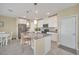 Modern kitchen with white cabinets, gray island and stainless steel appliances at 2854 Black Birch Dr, Ocoee, FL 34761