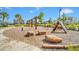 Community playground with wooden play structures and a soft ground surface at 2854 Black Birch Dr, Ocoee, FL 34761