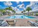 Inviting community pool with lounge chairs and palm trees at 2854 Black Birch Dr, Ocoee, FL 34761