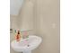 Small powder room with pedestal sink and mirror at 2854 Black Birch Dr, Ocoee, FL 34761