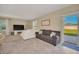 Living room with gray sectional sofa and access to backyard at 2854 Black Birch Dr, Ocoee, FL 34761