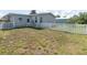 Backyard of a manufactured home with a white vinyl fence and a grassy area at 550 Saint Johns Rd, Tavares, FL 32778