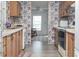 Kitchen with wood cabinets and patterned wallpaper at 550 Saint Johns Rd, Tavares, FL 32778