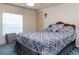 Bedroom with a double bed, gray bedding, and blue carpet at 550 Saint Johns Rd, Tavares, FL 32778