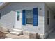 Exterior view of a light gray manufactured home with blue shutters and a small front yard at 550 Saint Johns Rd, Tavares, FL 32778
