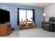 Living room featuring a large TV and comfortable seating at 550 Saint Johns Rd, Tavares, FL 32778