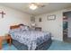 Bedroom with double bed, gray bedding, and blue carpet, plus an ensuite bathroom at 550 Saint Johns Rd, Tavares, FL 32778