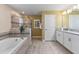 Elegant bathroom with soaking tub, walk-in shower, and double vanity at 8903 Stinger Dr, Davenport, FL 33896