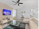 Bright living room featuring comfortable seating, large TV, and stylish coffee table at 8903 Stinger Dr, Davenport, FL 33896