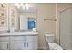 Clean bathroom with white cabinets, a large mirror, and a walk-in shower at 8903 Stinger Dr, Davenport, FL 33896