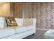 Living room featuring white sofa with gold pillow and city wallpaper at 8903 Stinger Dr, Davenport, FL 33896