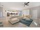 Open concept living room with sectional sofa and view into kitchen at 8903 Stinger Dr, Davenport, FL 33896