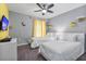 Fun bedroom with twin beds, minion-themed decor, and a ceiling fan at 8903 Stinger Dr, Davenport, FL 33896