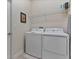 Convenient laundry room with washer, dryer, and storage shelves at 8903 Stinger Dr, Davenport, FL 33896