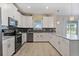 Spacious kitchen with white cabinets, stainless steel appliances, and a large island at 8903 Stinger Dr, Davenport, FL 33896