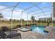 Screened-in pool and spa with lounge chairs at 8903 Stinger Dr, Davenport, FL 33896