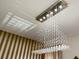 Modern crystal chandelier with sleek lines and a cascading design at 8903 Stinger Dr, Davenport, FL 33896