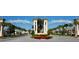 Grand entrance to Champions Gate community with lush landscaping at 8903 Stinger Dr, Davenport, FL 33896