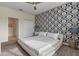 Bright bedroom with white bed and blue damask wallpaper at 8903 Stinger Dr, Davenport, FL 33896