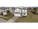 Two story home with a landscaped yard at 8903 Stinger Dr, Davenport, FL 33896