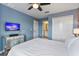 Comfortable bedroom with a TV and en-suite bathroom access at 8903 Stinger Dr, Davenport, FL 33896