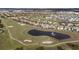 Aerial of golf course with homes and pond at 8903 Stinger Dr, Davenport, FL 33896