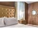 Elegant bedroom with gold headboard, white linens, and a crystal chandelier at 8903 Stinger Dr, Davenport, FL 33896