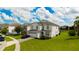 Two-story home with a three-car garage and landscaped yard at 8903 Stinger Dr, Davenport, FL 33896