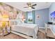 Serene bedroom with a floral wall mural, ceiling fan, and comfortable bed at 8903 Stinger Dr, Davenport, FL 33896