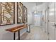 Bright entryway with wood accent table and large gold geometric mirrors at 8903 Stinger Dr, Davenport, FL 33896