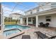 Private screened pool and spa with patio furniture at 8903 Stinger Dr, Davenport, FL 33896