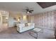 Relaxing living room with white sofa and city-themed wallpaper at 8903 Stinger Dr, Davenport, FL 33896