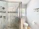 Large walk-in shower with marble tile and glass enclosure at 428 Short Pine Cir, Orlando, FL 32807
