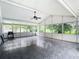Spacious screened porch with tile floor and ceiling fan, great for relaxing at 428 Short Pine Cir, Orlando, FL 32807