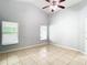 Spacious bedroom with high ceilings, tile flooring, and large windows at 428 Short Pine Cir, Orlando, FL 32807