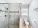 Walk-in shower with marble tile and glass enclosure at 428 Short Pine Cir, Orlando, FL 32807