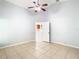 Spacious bedroom with tile floors, ceiling fan, and kitchen access at 428 Short Pine Cir, Orlando, FL 32807