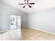 Bright bedroom with tile floors, ceiling fan, and access to a screened porch at 428 Short Pine Cir, Orlando, FL 32807