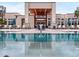 Resort-style pool with clubhouse and outdoor seating at 7740 Sandy Ridge Dr # 234, Reunion, FL 34747