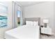Comfortable bedroom featuring a full-size bed, nightstand, and window views at 7740 Sandy Ridge Dr # 234, Reunion, FL 34747