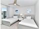 Guest bedroom with two twin-size beds, nightstand, and large window at 7740 Sandy Ridge Dr # 234, Reunion, FL 34747