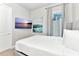 Cozy bedroom with a full-size bed, wall-mounted TV, and calming decor at 7740 Sandy Ridge Dr # 234, Reunion, FL 34747