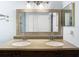 Double vanity bathroom with granite countertop and large mirror at 428 Short Pine Cir, Orlando, FL 32807
