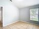 Bright bedroom with tile flooring and a window overlooking the backyard at 428 Short Pine Cir, Orlando, FL 32807