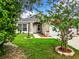 House exterior showcasing a front yard with flowering plants at 428 Short Pine Cir, Orlando, FL 32807