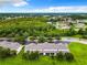 Aerial view of townhouses with lush green surroundings at 2543 Old Kent Cir, Kissimmee, FL 34758